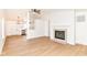Bright living room features hardwood floors, fireplace with white shiplap, and an open concept design at 11816 Wapiti Way, Noblesville, IN 46060