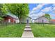 View of backyard, green lawn, and a concrete walkway at 1311 E Michigan St, Indianapolis, IN 46202