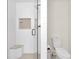 Modern bathroom featuring tiled walk-in shower, bench, and neutral finishes at 1311 E Michigan St, Indianapolis, IN 46202