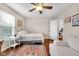Bright bedroom with a comfortable bed, side table, and cozy armchair seating area at 1311 E Michigan St, Indianapolis, IN 46202