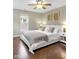 Relaxing bedroom with ceiling fan, neutral walls, hardwood floor, and comfortable king bed at 1311 E Michigan St, Indianapolis, IN 46202