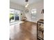 Bright dining area features modern light fixture, hardwood flooring, and access to the backyard at 1311 E Michigan St, Indianapolis, IN 46202