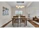 Warm dining area with a modern light fixture and a cozy rug beneath the wooden table at 1311 E Michigan St, Indianapolis, IN 46202