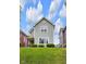 Charming two-story home featuring a covered porch and well-maintained lawn at 1311 E Michigan St, Indianapolis, IN 46202