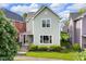 Charming two-story home featuring a well-maintained lawn and traditional architectural details at 1311 E Michigan St, Indianapolis, IN 46202