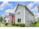 Side view of a two-story home highlighting the siding and window details on a sunny day at 1311 E Michigan St, Indianapolis, IN 46202