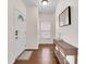 Bright foyer with hardwood floors, a decorative console table, and a stained-glass front door at 1311 E Michigan St, Indianapolis, IN 46202