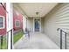 Cozy front porch with chairs, a detailed front door, and views of the neighborhood at 1311 E Michigan St, Indianapolis, IN 46202