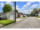 Street view of detached garages with white doors and driveways on a sunny day at 1311 E Michigan St, Indianapolis, IN 46202