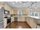 Well-lit kitchen with stainless steel appliances and classic cabinets; ideal for cooking at 1311 E Michigan St, Indianapolis, IN 46202