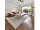 Open-concept living room featuring hardwood floors, a large window, and stylish furniture at 1311 E Michigan St, Indianapolis, IN 46202