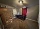 Bedroom featuring gray walls, carpet, and a simple bed, requiring repairs and updates to maximize its potential at 1314 Laurel St, Indianapolis, IN 46203