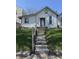 Charming home featuring a quaint facade, concrete steps, and green lawn, ready for renovation and landscaping at 1314 Laurel St, Indianapolis, IN 46203