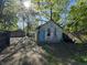Detached garage with peeling paint, offering potential for various uses at 1314 Laurel St, Indianapolis, IN 46203