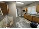 Kitchen featuring gray walls, damaged floors, and plain cabinets, awaiting renovation and modernization to maximize its potential at 1314 Laurel St, Indianapolis, IN 46203