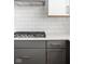 Close-up of the gas cooktop and tile backsplash in the modern kitchen at 1322 Colere Pl, Indianapolis, IN 46203