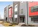Modern townhome featuring a vibrant red accent and stylish gray and brick facade at 1322 Colere Pl, Indianapolis, IN 46203