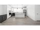 Bright open kitchen with gray and white cabinets, island, and stainless steel appliances at 1322 Colere Pl, Indianapolis, IN 46203