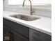 Detailed view of the kitchen sink with white countertop and brass faucet at 1322 Colere Pl, Indianapolis, IN 46203