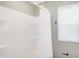 Bright bathroom featuring a white shower tub and window for natural light at 1429 Deloss St, Indianapolis, IN 46201
