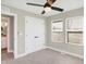 Bedroom with ensuite bathroom and closet, featuring a ceiling fan and large windows at 1429 Deloss St, Indianapolis, IN 46201