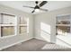 Bedroom featuring three windows offering natural light, with a ceiling fan at 1429 Deloss St, Indianapolis, IN 46201