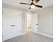 This bedroom features neutral walls, modern ceiling fan, plush carpet, and closet for ample storage at 1429 Deloss St, Indianapolis, IN 46201