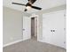 This bedroom features neutral walls, modern ceiling fan, plush carpet, and closet for ample storage at 1429 Deloss St, Indianapolis, IN 46201