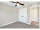 This bedroom features neutral walls, modern ceiling fan, plush carpet, and closet for ample storage at 1429 Deloss St, Indianapolis, IN 46201