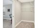 Walk-in closet offering ample storage space, adjacent to carpeted bedroom with natural light at 1429 Deloss St, Indianapolis, IN 46201