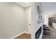 Hallway featuring an electric fireplace and view of kitchen and living spaces at 1429 Deloss St, Indianapolis, IN 46201