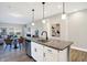 Open-concept kitchen features a large island with granite countertops and a stainless steel dishwasher at 1429 Deloss St, Indianapolis, IN 46201