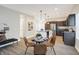 Open-concept kitchen and dining area with granite countertops and stainless steel appliances at 1429 Deloss St, Indianapolis, IN 46201