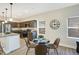 Eat-in kitchen features a dining table, granite countertops, stainless appliances and modern pendant lighting at 1429 Deloss St, Indianapolis, IN 46201