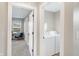 Bright laundry room features a full-size washer and dryer and a view into another room at 1429 Deloss St, Indianapolis, IN 46201