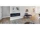 Modern living room featuring an electric fireplace, bench seating and stylish decor at 1429 Deloss St, Indianapolis, IN 46201