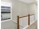 Upstairs hallway with wood railing and view of exterior at 1429 Deloss St, Indianapolis, IN 46201