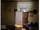 Bedroom with natural light and original wood trim, showcasing potential for a cozy retreat at 155 S Elder Ave, Indianapolis, IN 46222