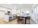 Bright kitchen with white cabinets, a breakfast bar, and an adjacent dining area perfect for entertaining at 1577 Vision Ct, Danville, IN 46122