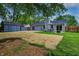View of the backyard with a detached shed, patio set, and partially reseeded lawn at 1604 Stacy Lynn Dr, Indianapolis, IN 46231