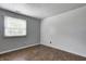 Bright bedroom with a window overlooking the yard, complemented by wood-look flooring and a textured ceiling at 1604 Stacy Lynn Dr, Indianapolis, IN 46231