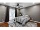 Bedroom with dark wood flooring and a ceiling fan, providing a modern touch with ample natural light at 1604 Stacy Lynn Dr, Indianapolis, IN 46231