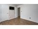This bedroom features sleek, wood-look floors, neutral walls, and a conveniently mounted television for modern comfort at 1604 Stacy Lynn Dr, Indianapolis, IN 46231