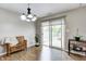 Well-lit dining area featuring modern chandelier, bench seating, and sliding glass doors to the backyard patio at 1604 Stacy Lynn Dr, Indianapolis, IN 46231