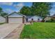 Charming single-story home with a well-manicured lawn and a brick and siding exterior at 1604 Stacy Lynn Dr, Indianapolis, IN 46231