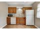 Bright kitchen features wood cabinets, stainless steel sink, and white appliances at 1604 Stacy Lynn Dr, Indianapolis, IN 46231