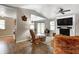 Bright living room with vaulted ceilings, white brick fireplace, and modern ceiling fan at 1604 Stacy Lynn Dr, Indianapolis, IN 46231