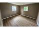 Bedroom featuring hard surface floors, neutral walls, and two large windows at 1614 Dayton Ave, Indianapolis, IN 46203
