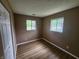 Bedroom featuring hard surface floors, neutral walls, and two large windows at 1614 Dayton Ave, Indianapolis, IN 46203