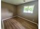 Bedroom featuring hard surface floors, neutral walls, and a large window at 1614 Dayton Ave, Indianapolis, IN 46203
